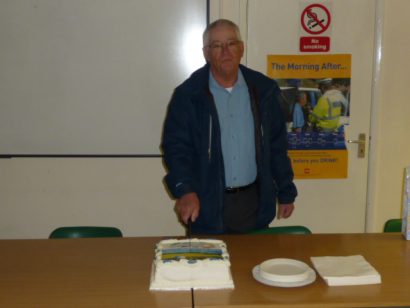John Bentley cutting his retirement cake.