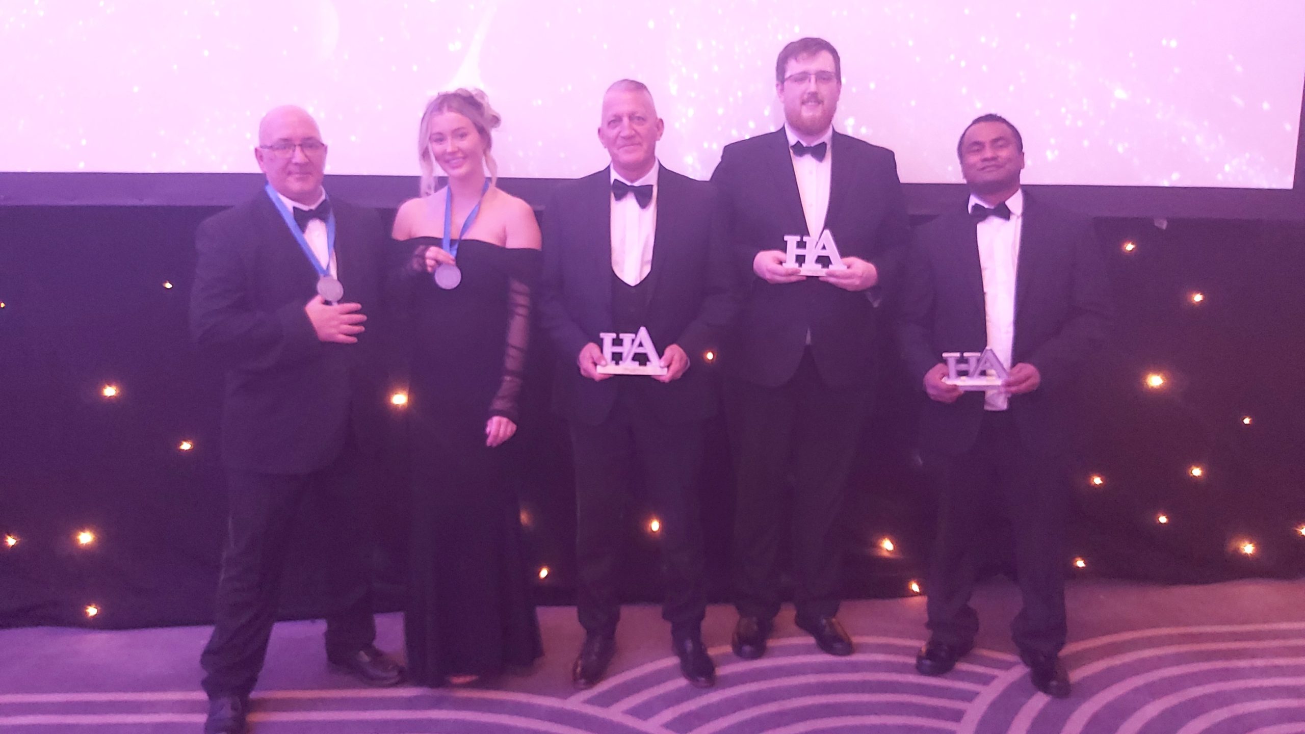 A group of people in black tie attire at the Heroes Awards.