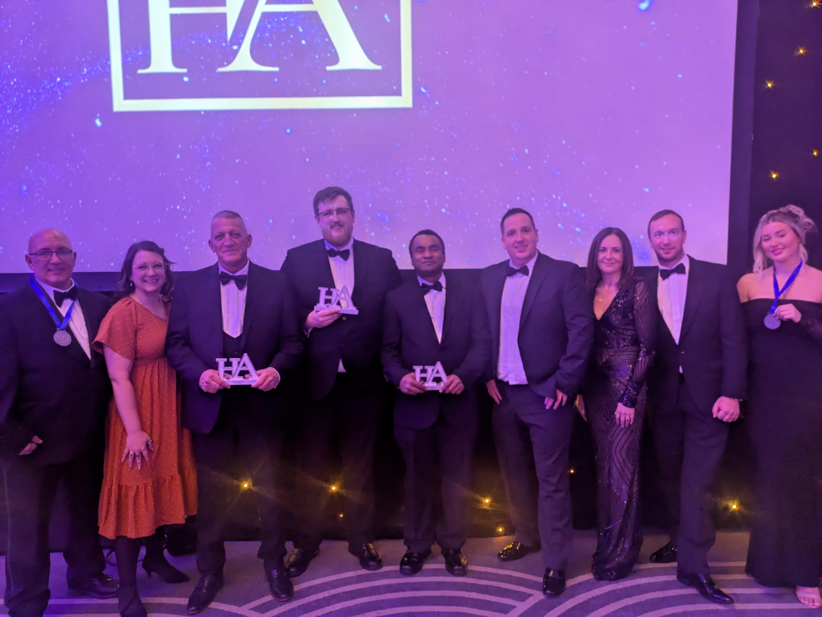 A group of people in black tie attire at the Heroes Awards.